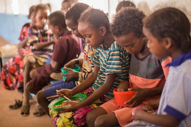 Children eat together at school in Kenya.