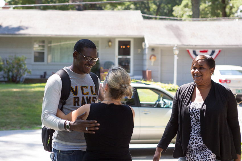 Momodou M. Bah of the Gambia accompanied by his sister Sunkaru Bah meets Debbie Gautreau, who sponsored him as a child through the ChildFund more than 20 years ago, for the first time in her house in Northborough, MA on August 8, 2015.