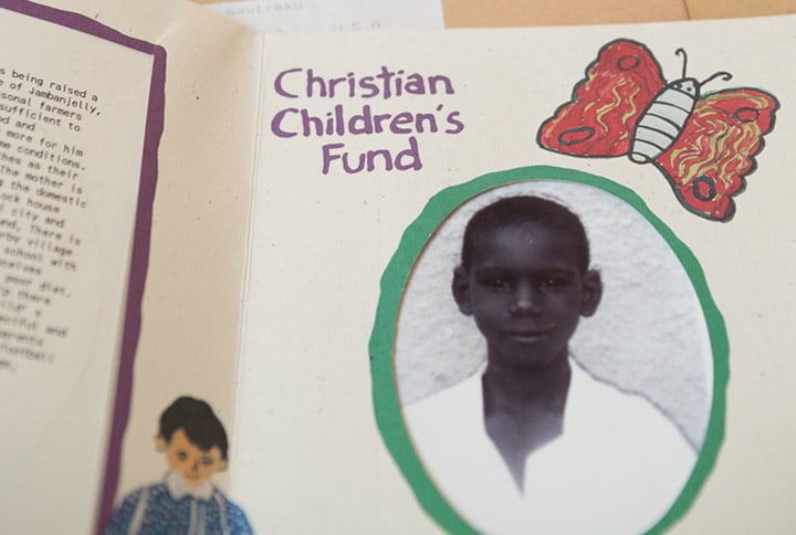 An introductory picture of Momodou M. Bah and letters that Debbie Gautreau received from the boy and the ChildFund, while sponsoring him through the organization, photographed in her home in Northborough, MA on August 8, 2015.
