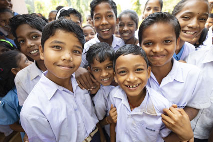 Group of kids in school uniforms standing outside in India