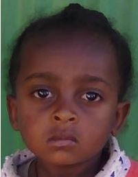 Young girl from Ethiopia looking at the camera unsmiling