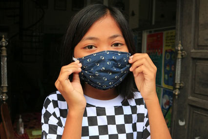 Girl wearing facemask in Indonesia.