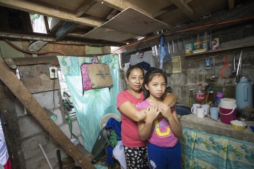 Woman and girl at home in Philippines.