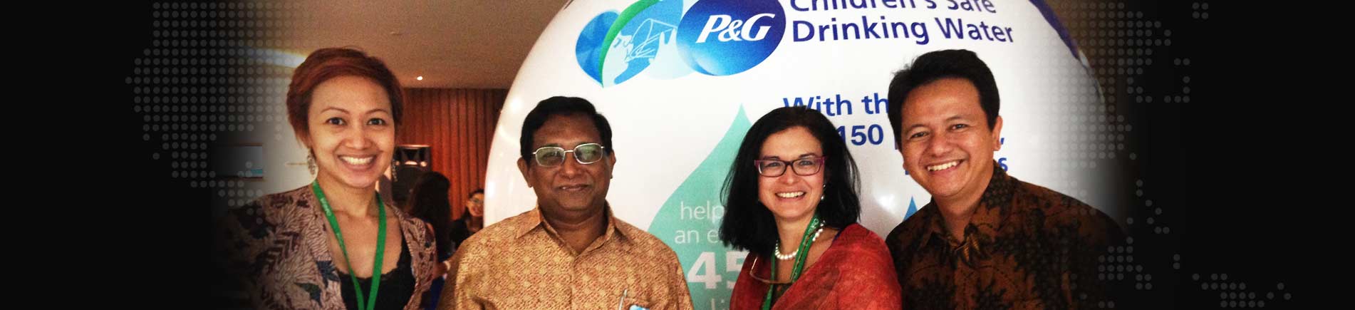 Smiling adults in front of a P&G display