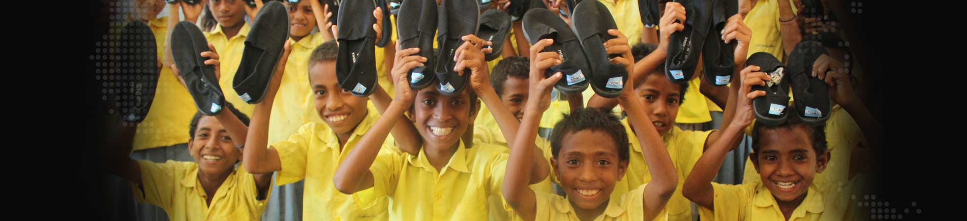Smiling children with shoes