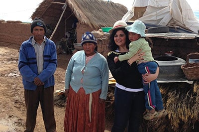 Caroline, of France, meets her sponsored child María and her family at María's home in La Paz, Bolivia. 