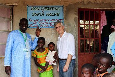 Ron Wolfe, a ChildFund staff member, visiting with his 11-year-old sponsored child and her family in The Gambia.